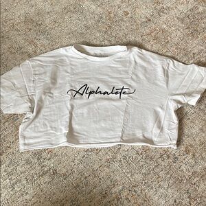 Alphalete White Crop Tee with Black Script Logo